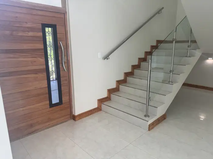 The timber front door and the staircase rising from the entrance