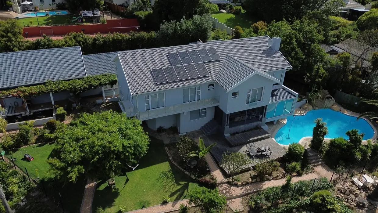 A completed AEP home seen from the air, with its garden and pool