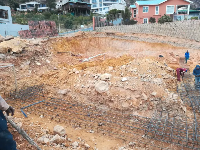 The foundations at House Chapman with the mountain behind the site