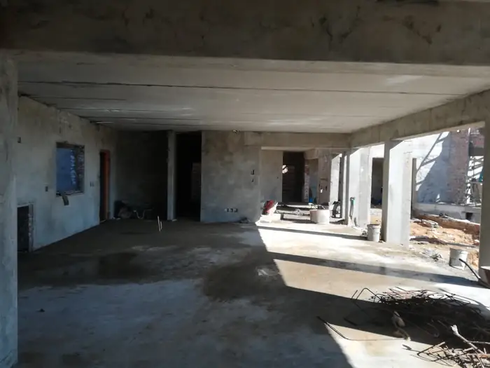 The open plan living volume at House Chapman before the finishes