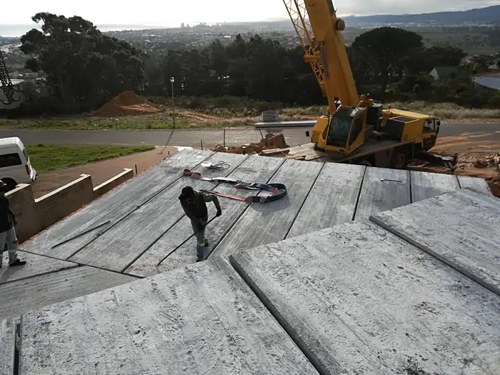 Precast slab panels being landed and set at House Chapman