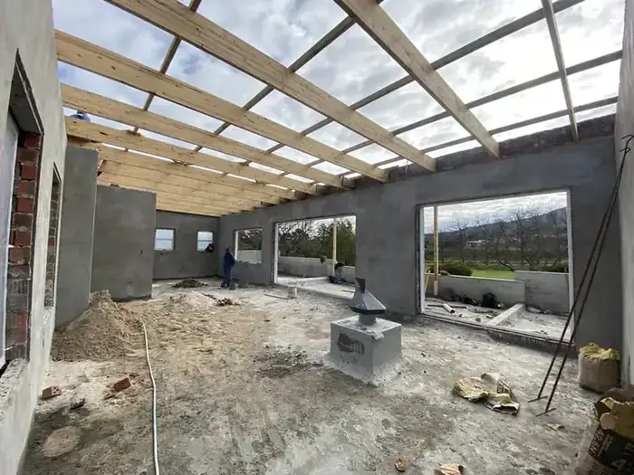 Inside the new storey, roof timbers up and the Erinvale fairways through the openings