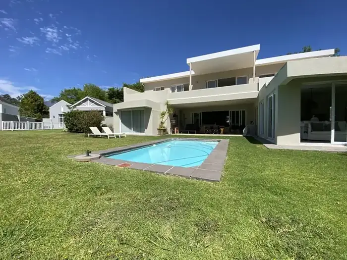 The finished home from the pool and garden
