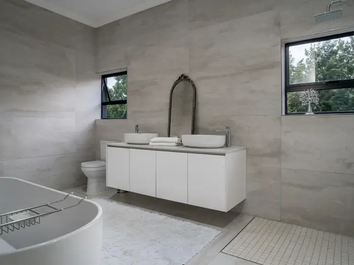 The main bathroom at House Hillcrest with a freestanding bath and a double vanity