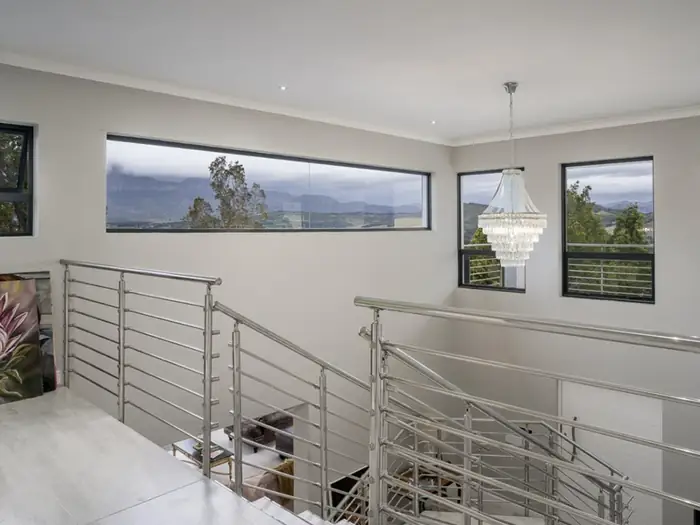 The upstairs landing at House Hillcrest, with strip windows looking out over the reserve