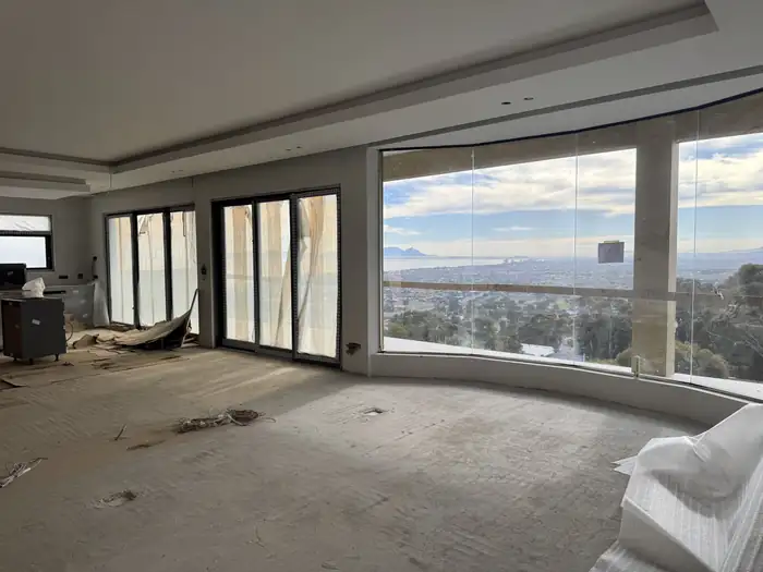 The curved glazed living area at House Makhene looking out over False Bay