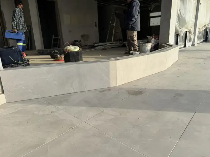 The curved terrace slab being finished by hand on site