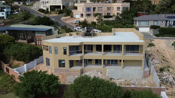 The bay elevation of House Makhene with the terraces and glazing in