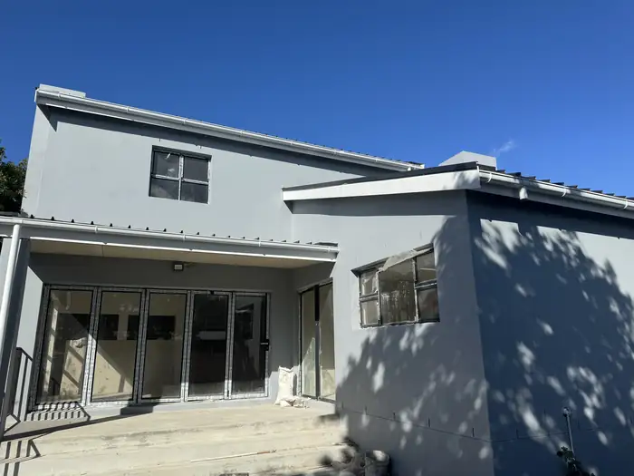 The back of the house with the aluminium stacker doors and windows in and the house closed up