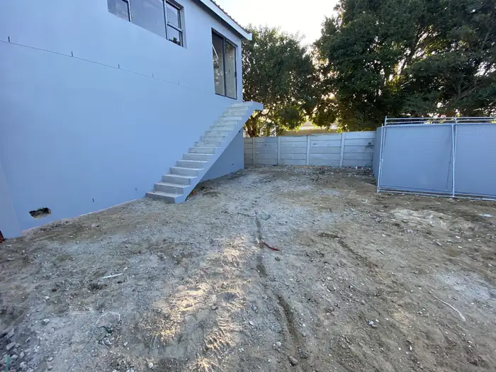 The painted external staircase running up to the first floor