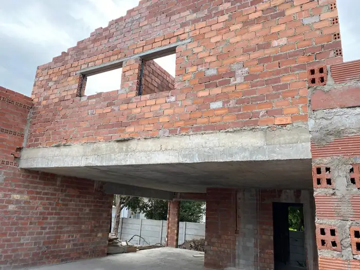 The cast concrete first floor slab spanning over the open ground floor