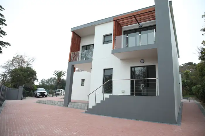 One of the houses from the driveway, the timber pergola over the upper balcony