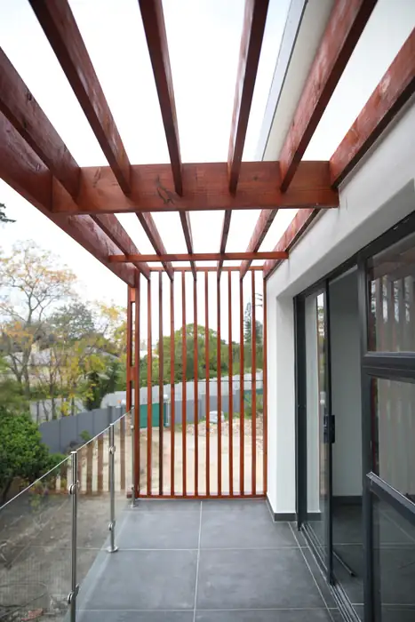Looking up through the timber pergola over the entrance