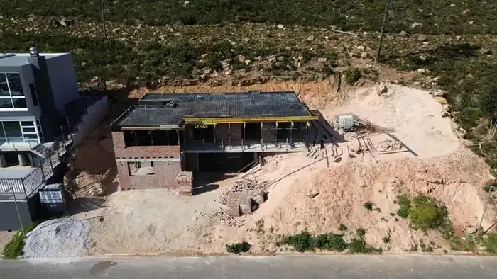 The deep excavation cut into the mountainside for the lower level