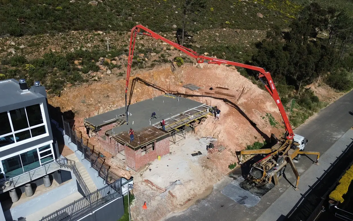 House van der Westhuizen: the pump reaching over the site to cast the first floor slab