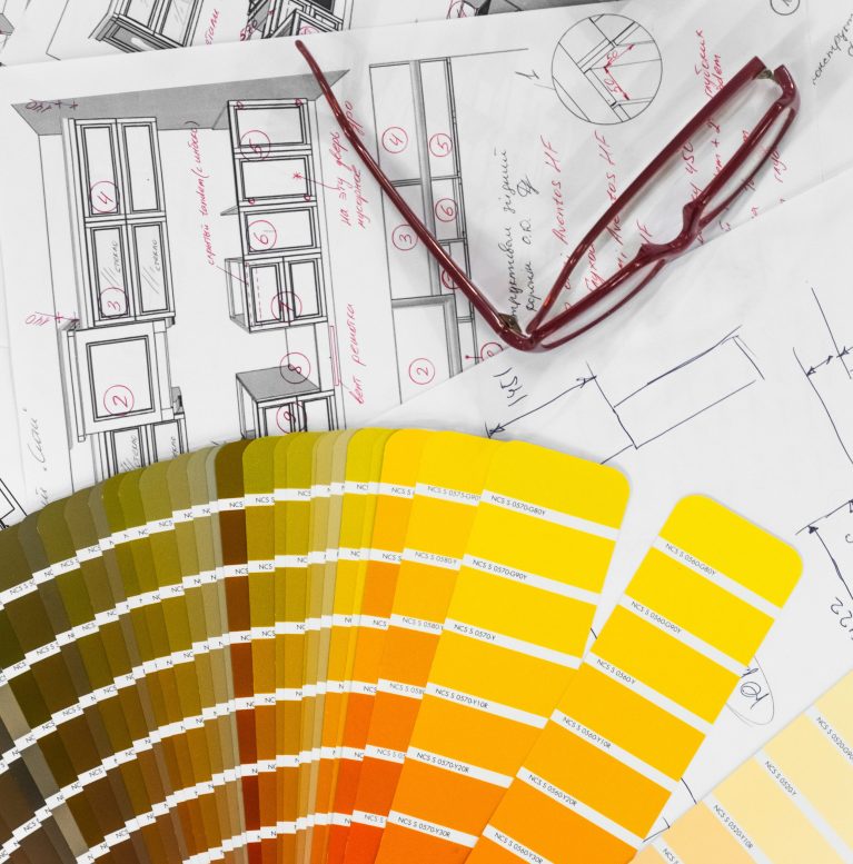 Architectural blueprint interior with wooden and paper samples and a multi-colored palette and draw tools
